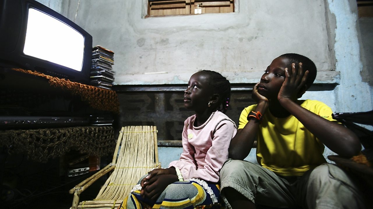 A young man introducing his little brother to data processing, on a laptop