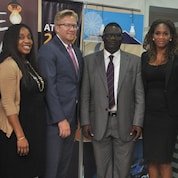 Team members of both brands pose for a picture