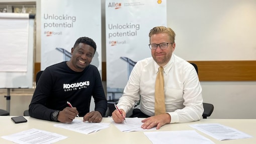 two men writing on a paper